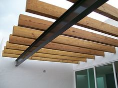 a close up view of the underside of a wooden structure with metal bars on it