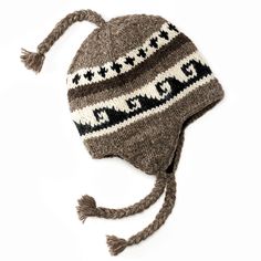 a knitted hat with tassels is shown on a white background and has an attached ear flap