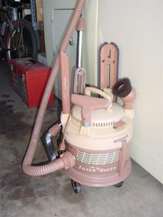 a pink vacuum is sitting on the floor