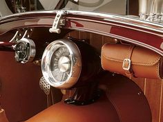 the interior of an old car with leather seats and gauges on the steering wheel