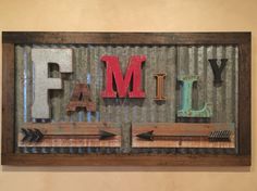 the word family is made up of letters and arrows in an old metal box frame