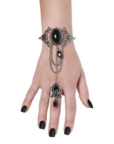 Add a gorgeous touch to your dark and devilish costume with this black and silvertone hand chain. With delicate metallic chains and black stone accents, this ring and bracelet duo will take your look from drab to fab. Dimensions: 5"H x 3.5"W Material: Iron, plastic Imported Undergarment Fashion, Vampire Costumes, Gothic Angel, Ring And Bracelet, Gothic Themes, Goth Hair, Spencers Gifts, Halloween Accessories, Hand Chain