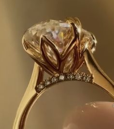 a close up of a gold ring with a diamond on it's center stone