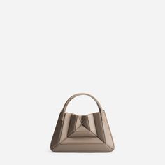 Mix of symmetry and fluid, clean lines, Mini Sera Tote is designed to carry your daily essentials, a large phone (like iPhone Pro Max), mini wallet or cardholder, and lipstick, etc.Its exterior design is a surrealist dream, reminiscent of a maze-like structure protruding outwards, with sharp, clean lines, and a 3D façade. Opening the top handles reveals a suede drawstring top edge, securing your belongings on the go.Folding inwards like an accordion and then stretching outwards to store those la Modern Evening Bag With Card Slots, Modern Evening Bags With Card Slots, Modern Office Bags With Card Slots, Modern Office Bag With Card Slots, Iphone Pro, Drawstring Top, Secret Sale, Mini Wallet, New Launch