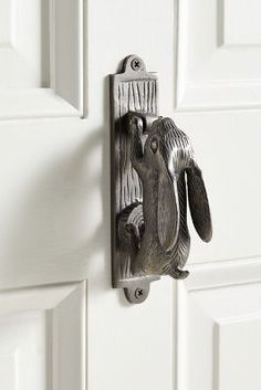 an elephant door handle on a white door