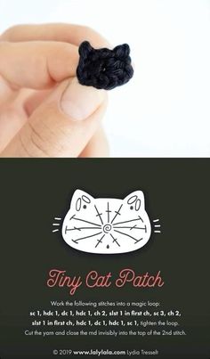 a hand holding a tiny black crochet cat pin with the words tiny cat patch on it