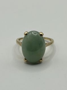 Jade With 14 karat Gold ring, Weight 6grams, size 8. Timeless 14k Gold Collectible Rings, Formal 14k Gold Cabochon Rings, Fine Jewelry 14k Gold Ring With Large Stone, Classic Domed Emerald Ring For Formal Occasions, Yellow Gold Rings With Large Stone, 14k Gold Jewelry With Large Stone For Formal Events, 14k Gold Ring With Large Stone For Anniversary, Oval 14k Gold Rings For Collectors, Classic 14k Gold Opal Ring