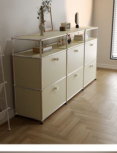 a white dresser sitting on top of a hard wood floor