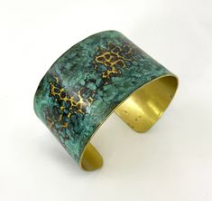 These unique, hand-formed copper and brass cuff bracelets with vibrant patinas create stunning accents to your personal style. Dress up or down- either way you'll be wearing an adornment that will turn heads, start conversations, and delight the eye of the beholder. Hammered Brass cuff with bright brass peeking through a lovely marbled green/blue patina. Please note that patina colors will look different depending on the screen/device you view them on. This is a medium cuff- see measurements bel Brass Cuff Bracelet With Patina As A Gift, Bronze Brass Bracelet With Patina, Bronze Brass Bracelets With Patina, Patina Brass Bangle Bracelet, Brass Bangle Bracelet With Patina, Unique Green Patina Cuff Bracelet, Copper Cuff Bracelet With Patina As Gift, Gold Copper Cuff Bracelet With Patina, Green Patina Cuff Bracelet Bangle