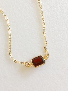 Lovely burgundy red natural garnet gemstone set in 24k gold vermeil bezel. Pendant is 6 x 8 mm and suspended from delicate sparkling 14k gold fill cable chain with matching spring ring clasp. Available in several lengths. Beautiful minimalist necklace makes lovely gift for a January birthday or Valentine sweetheart! Brown Faceted Jewelry Gift, Amber Garnet Jewelry As Gift, Amber Garnet Jewelry For Gift, Amber Garnet Jewelry Gift, Gold Ruby Necklaces With Bezel Setting, Dainty Garnet Gemstone Jewelry, Gold Garnet Necklace For Gift, Gold Garnet Birthstone Necklace, Gold Garnet Jewelry With Bezel Setting