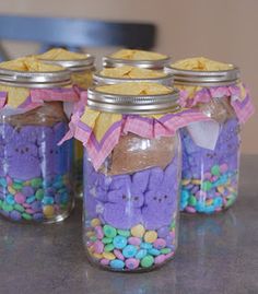 three mason jars filled with candy and candies