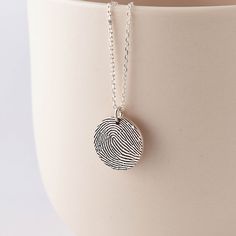 "** CIRCLE PENDANT FINGERPRINT NECKLACE, available in sterling silver, with silver, 18k gold plated or 18k rose gold plated finish. This necklace can be engraved with the fingerprints of your loved ones. We can work with any photo of the fingerprint on paper that is no special kit required. Engravable on the back of the pendant with 1 word or date on the back of the necklace. I T E M ∙ D E T A I L S * Material: Sterling silver * Word limits: 3-4 words or a date on the back * By default, the engr Minimalist Hand Stamped Memorial Jewelry, Silver Hand Stamped Jewelry For Commemoration, Commemorative Hand Stamped Silver Jewelry, Minimalist Etched Jewelry For Keepsake, Personalized Etched Sterling Silver Necklace, Thumbprint Jewelry, Mom Loss, In Memory Of Mom, Thumbprint Necklace