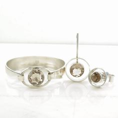 "Smoky Quartz Sterling Silver Jewelry Set by Niels Erik From, Circa 1960s Weights- Bracelet: 31.2 grams, Pendant: 7.1 grams, Ring: 9.6 grams Measurements: The bracelet will comfortably fit a wrist size of 6 1/2\". The pendant is 1 3/4\" x 15/16\". The ring size is 7 1/4. Markings- Bracelet: Sterling, Denmark, Nefrom (Niels Erik From), 925S, Pendant and Ring: From (Niels Erik From), 925S,  Color: Brown-ish Stone/s: Smoky Quartz (Natural) Condition: Very good, some light scratches/nicks on bracele Mid-century Polished Formal Jewelry, Mid-century Polished Finish Jewelry For Anniversary, Silver Jewelry Set, Silver Jewellery Sets, Fine Jewelry Bracelets, Bracelets And Charms, Smoky Quartz, Jewelry Set, Sterling Silver Jewelry