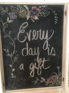 a chalkboard sign that says, every day is a gift