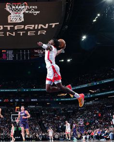 a basketball player jumping up in the air