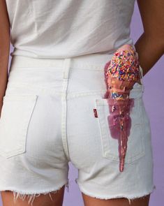 a person wearing white pants with sprinkles on them and an ice cream cone sticking out of the pocket