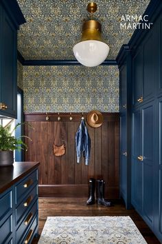 an entryway with blue cabinets and wooden flooring is shown in this image, there are