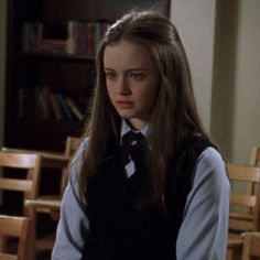 two girls in school uniforms standing next to each other