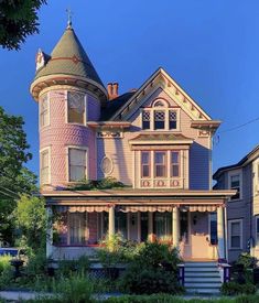 a pink victorian style house in the suburbs