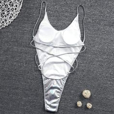 Metallic Glitter Light Silver One Piece Solid High Cut Beachwear QUICK DRY AND COMFORTABLE FABRIC - 82% polyester, 18% spandex. Length of clothing (from shoulder to bottom, measured vertically): S-25.2inch, M-26.0inch, L-27.2inch, XL-28.0inch. PERFECT FOR: Dancing, music festival clothes, rave outfits, concert clothing, party attire, club wear, EDM clothing, and other events. SHOW OFF YOUR BEST ASSETS: This hologram bodysuit features a sexy high leg cut with a scoop neck. Made of semi-stretchy, Silver One Piece, Backless One Piece Swimsuit, Edm Outfits, Stand Collar Shirt, Music Festival Outfits, Collared Shirt Dress, Swimsuits Hot, Rave Outfits, Swim Dress