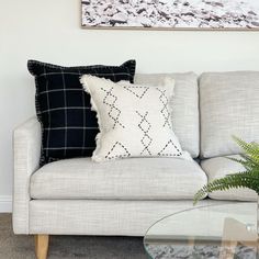 a white couch with black and white pillows