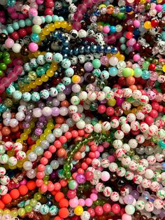 many different colored beads are stacked together