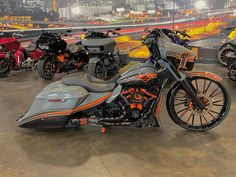 several motorcycles are lined up on display in a showroom with city lights behind them