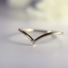 a diamond ring sitting on top of a table