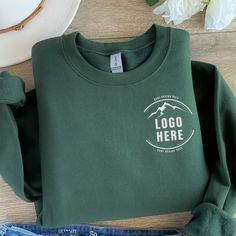 Custom Embroidered Logo Text Sweatshirt, Embroidered Business Logo Unisex Sweater, Monogram Company Name Crewneck, Logo Business Uniform Tee Looking for the perfect custom logo embroidery sweatshirt? All orders are shipped the next day and are backed by our 100% Love it Guarantee. 💚 How to Order  1) Please check all the photos from the listing. 2) Please choose your shirt size, thread color and sweatshirt color. (Sweatshirt sizes and thread colors are shown on the listing photos) 3) Add your pe Cheap Crew Sweatshirt With Team Name, Green Cotton Sweater With Logo Print, Green Long Sleeve Top With Embroidered Logo, Green Embroidered Tops For Winter, Green Embroidered Crew Top, Green Embroidered Crew Neck Top, Crew Neck Tops With Embroidered Logo For Winter, Winter Crew Neck Top With Embroidered Logo, Green Embroidered Crew Neck Sweater