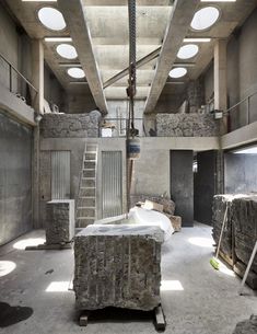 an empty room with stone walls and stairs leading up to the second floor that has been converted into a loft