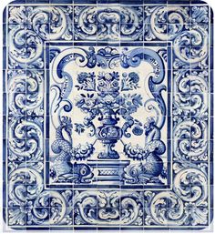 a blue and white tile with an ornate design