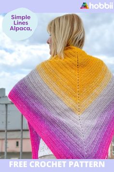 a woman wearing a colorful crochet shawl with the text, simple lines alpaca, free crochet pattern