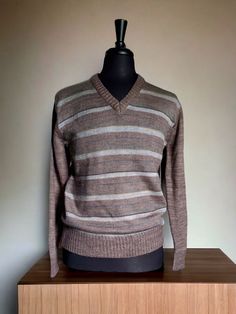 Vintage 70's-80's striped acrylic sweater with some great muted colors and spacedye knit pattern. Excellent condition and ready to be your cozy body friend for the remaining cold months ahead. Made by Peman. Love the V-neck style. Measurements Shoulder seam- 17.5"  Chest- 40" up to 46" stretched Length- 27"  Sleeve length- 26.5" All sales are final. Please reach out with questions prior to purchasing, I am happy to help! Striped Wool Sweater With Long Sleeves, Striped Long Sleeve V-neck Sweater For Winter, Winter Striped V-neck Sweater With Long Sleeves, Winter Striped Long Sleeve V-neck Sweater, Winter Striped V-neck Long Sleeve Sweater, Retro Striped Knitted Sweater, Retro Striped Sweater For Winter, Retro Striped Winter Sweater, Multicolor Wool V-neck Sweater