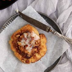 a pastry on a plate with a knife next to it