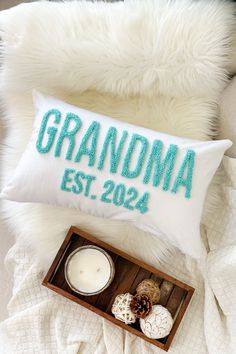 a personalized pillow and candle on a bed