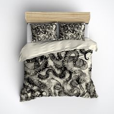 a black and white bed with an intricately designed comforter