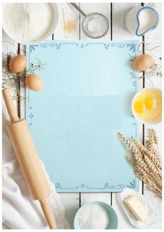 an overhead view of baking supplies on a white wooden table with a blue board in the middle