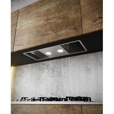 an oven hood mounted on the side of a wall with wooden paneling and lights