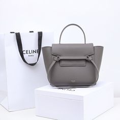 PT - COL Bags - 246 Modern Bucket Bag With Top Carry Handle For Gift, Modern Double Handle Box Bag For Gift, Modern Double Handle Box Bag As Gift, Modern Square Bucket Bag As Gift, Chic Gray Shoulder Bag With Dust Bag, Modern Gray Square Shoulder Bag, Modern Gray Shoulder Bag With Dust Bag, Elegant Gray Bag For Gift, Luxury Clutch