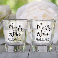 two shot glasses with mr and mrs written on the side sitting next to each other