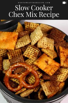 a bowl filled with chex mix and pretzel crackers in the middle