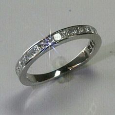 a white gold wedding ring with princess cut diamonds