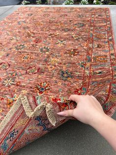 a person is holding onto a rug on the ground