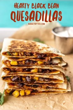 three quesadillas stacked on top of each other with text overlay reading hearty black bean quesadillas