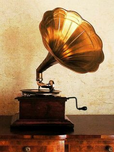 an old phonograph sitting on top of a wooden dresser