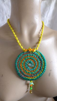 a woman's torso wearing a necklace made with beads and bead work on it