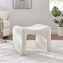 a white stool sitting on top of a rug in a living room