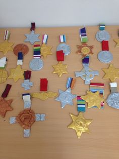 many medals are placed on a wooden table