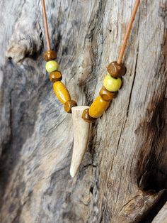 "Stunning rustic style Deer Antler Tine Necklace. This leather necklace is adorned with beautiful brown & green wood beads. These are real deer antler tines, wonderful for those who enjoy rustic outdoor style jewelry. You will get one necklace with this listing, and it will vary slightly as these are real antlers. They will be the same size and shape as in the photos, with very minor differences. Very unique piece of rustic themed jewelry. Excellent gift for those who love hunting and/or the out Adjustable Green Rustic Necklace, Adjustable Rustic Green Necklace, Adjustable Brown Beaded Necklaces Nature-inspired, Deer Horn Jewelry, Antler Beads, Deer Antler Necklace, Deer Antler Jewelry, American Indian Crafts, Twine And Twig