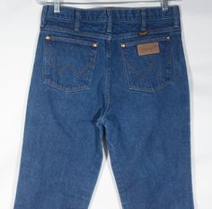 These are fabulous early 80s Wrangler's western jeans that are soft, worn-in, faded, and in great shape with sturdy medium blue wash cotton thick denim. You will love kicking around in these made in U.S.A. jeans classics. The label says they are a size 33 x 36, but have shrunk over time and now measure a size **32 x 34**. Flat measurements are included here to check fit. These jeans are in great, worn-in condition with loads of character and signs of use/wearing/fading and one spot of discoloration around the knee (see last picture close up). Check out the photos and get these great keepers! --Flat Measurements, double for circumference--     Waist: 16"     Hip: 18.5"     Inseam: 34"     Waist to Hem: 45"     Rise: 11"     Bootcut Hem Width: 8.25 80s Jeans, Cowboy Ranch, Western Jeans, Work Jeans, Vintage Wrangler, Medium Blue, Rodeo, Mens Jeans, Close Up